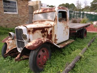 rusted old truck sitting in our side yard