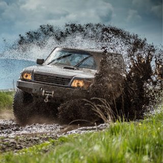 Truck driving through mud - safe with Classy Chassis's Spray-On Lining!